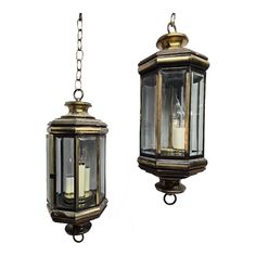 two old fashioned hanging lanterns with one light on each side and the other off to the side