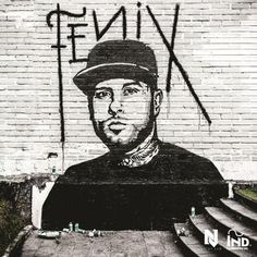 a mural on the side of a building with a man wearing a hat and holding a baseball bat