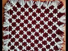 a red and white crocheted doily with flowers on it