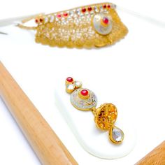 Experience sheer elegance with our Exclusive Enameled Kundan Choker Set, boasting exquisite Kundan stones and crafted with 22k antique gold weighing 63.7 grams. This opulent set features an adjustable length of 14" with 1" links and a secure hook lock. The stunning choker has a width of 1.75" and a drop length of 0.75". It also includes matching earrings, 2.3" in length with screw backs. Make a bold statement with this unique and timeless piece, finished with a regal antique gold shine. PRODUCT Gold Choker Set, Kundan Choker Set, Kundan Choker, Lock Style, Choker Set, Gold Choker, 22k Gold, Matching Earrings, Timeless Pieces