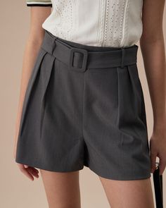 Fabric: This Belted Pleated Shorts is made of Polyester and Spandex. Polyester is an artificial fiber that feels soft, looks lustrous, and dries fast. Spandex is lightweight and comfortable to wear, resistant to sweat, has excellent elasticity, and is durable and robust. 
 Description: Designed with a modern high-waisted silhouette, these shorts offer a flattering fit that accentuates the waist while providing comfort and style. The pleated front adds a touch of sophistication, making them suita Elegant Stretch Shorts For Workwear, Fitted Belted Short Bottoms, Workwear Pants With Short Inseam And Elastic Waistband, Fitted Short Belted Bottoms, Gray Bottoms With Belt Loops, Modern Fitted Bottoms With Short Inseam, Elegant High Waist Stretch Shorts, Elegant Bottoms With Short Inseam, Short Bottoms With Belt Loops