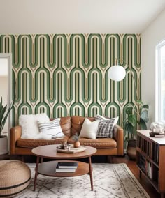 a living room filled with furniture and a large wallpapered pattern on the wall