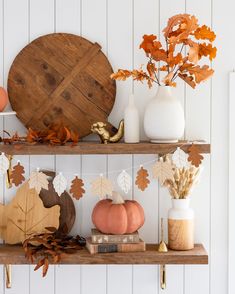 the shelves are decorated with fall leaves and pumpkins