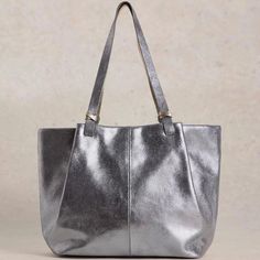 A tote bag that says: "I’ve arrived." Shimmery, all-over metallic detail for making a statement. And lots of space inside. Includes interior full-width & depth zip pocket and side slip pocket. 12" handle drop. Bag is 17"W x 12"H x 7"D Materials: Outer: 100% Leather. Inner: 100% Cotton Everyday Tote Bag With Silver-tone Hardware, Daily Use Satchel Tote With Silver-tone Hardware, Chic Metallic Shoulder Bag For Everyday Use, Daily Use Satchel With Silver-tone Hardware And Tote Shape, Daily Use Tote Satchel With Silver-tone Hardware, Daily Use Tote Shoulder Bag With Silver-tone Hardware, Metallic Leather Shoulder Bag For Everyday, Chic Metallic Bags For Everyday Use, Metallic Tote Bag For Travel