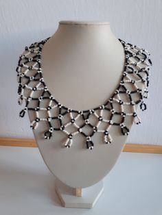 Vintage white and black crocheted lace glass seeds collar necklace.  Good condition. Inner size: 18 inches; 2.5 inches N to S.  IMPORTANT TO READ: To make this a smooth and pleasant transaction experience for everyone, all buyers need to read and understand the description, the terms of sale , the payment and the shipping indicated in this listing. TERMS OF SALE A. SHIPPING WORLDWIDE This listing includes the shipping fees indicated below. B. CARRIERS We don't ship with FedEx, DHL or UPS or any other carrier except for Canada Post unless a specific agreement with the buyer is accepted by us at our sole discretion and related handling fees may apply. C. HANDLING TIME We ship within 2 business days after the payment is received. D. DELAYS IN DELIVERY Any delays in deliveries are not our resp Beaded Jewelry Necklaces, Black Crochet, Glass Gifts, Collar Necklace, Crochet Lace, White Vintage, Choker Necklace, White And Black, Necklace Etsy