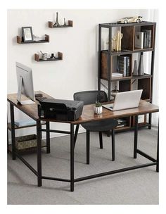 a computer desk with a laptop on it in front of a bookshelf and shelves