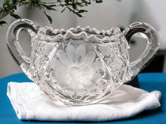 a clear glass vase sitting on top of a white cloth