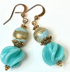 "Vintage Japanese Fin Glass Beads Aqua Blue , Vintage German Blue Gold Swirled Lucite Beads, Gold Plated French Ear Wires Vintage Japanese glass beads from the 1940s known as ' fin ' beads have been combined with vintage German lucite beads from the 1950s for an earring of swirled patterns - the Japanese aqua blue glass bead measures approximately  1/2\" in diameter . The vintage German bead above it is approximately 3/8\" in diameter and features swirls in both antiqued gold and deep teal blue Elegant Light Blue Jewelry With Large Beads, Turquoise Earrings With Large Beads For Gifts, Elegant Adjustable Beaded Glass Earrings, Elegant Beaded Earrings With Large Beads, Vintage Turquoise Earrings With Round Beads, Handmade Vintage Turquoise Beaded Earrings, Elegant Earrings With Colorful Czech Glass Beads, Turquoise Earrings With Colorful Czech Glass Beads, Elegant Beaded Earrings With Large Beads For Gift