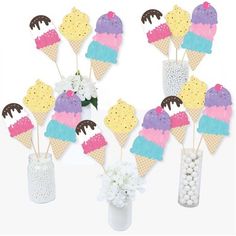 ice cream cones and flowers in vases on a table