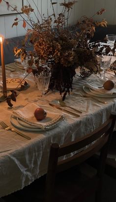 the table is set with plates and place settings