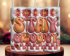 a birthday cake that says stay grooy on it with candles in the shape of flowers