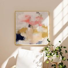 a painting hanging on the wall next to a chair with a potted plant in it