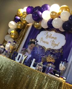 a purple and gold birthday party with balloons, streamers, cake table and welcome princess royal sign