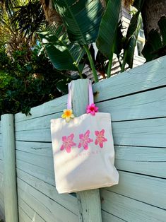 Our Sunhoney Hibiscus Tote Bag is the perfect summer time essential. Say hello to your new favorite beach, grocery, weekend tote bag! This tote features our classic hibiscus flower with Sunhoney underneath with classic canvas material, pink straps, gusset bottom and hold all the essentials and more! 100% Cotton All accessories are final sale. Summer Wishlist Ideas, Pink Canvas Beach Bag, Summer Pink Cotton Beach Bag, Pink Summer Cotton Beach Bag, Pink Canvas Beach Bag For Summer, Summer Pink Canvas Beach Bag, Pink Cotton Summer Beach Bag, Pink Cotton Beach Bag For Vacation, Pink Canvas Bag For Summer