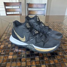 Elevate your game with these stylish Nike Kyrie 5 sneakers in black and metallic gold. Designed for men who want to make a statement on the court, these sneakers have a sleek and modern look that will surely turn heads. The black colorway is accented with hints of metallic gold, giving these shoes a luxurious and high-end feel. Used for one season of basketball still in great condition and stylish Nike Kyrie 5, Kyrie 5, Nike Kyrie, Black Metallic, The Court, Metallic Gold, Gold Metal, The Black, Basketball