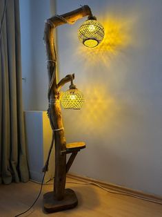 a lamp that is sitting on top of a wooden table next to a window with curtains