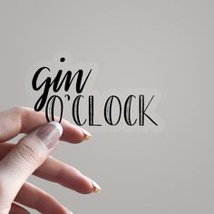 someone holding their hand with the word gin o'clock written on it in cursive writing