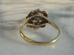 This is a beautiful antique Georgian piece that has been converted to a ring (the top is Georgian and the shank is modern). The rose cut diamonds are set in silver crimped collet closed back settings. The yellow gold split shank was added later. I purchased this piece as a ring, so I'm not sure when it was converted. There are no hallmarks, but the gold band has been tested to at least 14K. The ring is approximately US size 6.5 and can be sized. The ring comes with a letter of authentication (se Antique Emerald Diamond Ring With Brilliant Cut, Antique Emerald Ring With Brilliant Cut For Formal Occasions, Antique Gold Diamond Ring With Rose Cut Diamonds, Antique Yellow Gold Rings With Rose Cut Diamonds, Vintage Marquise Emerald Ring For Formal Occasions, Antique Oval Sapphire Ring With Single Cut Diamonds, Victorian Style Formal Cluster Ring With Rose Cut Diamonds, Victorian Diamond Jewelry With Screw Back, Antique Hallmarked Emerald Ring In White Gold