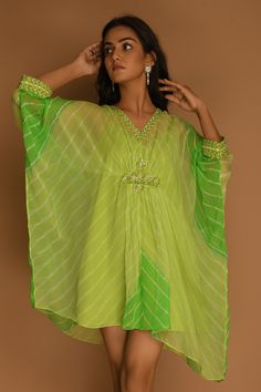 Lime green kaftan-style dress with all-over stripes, embroidered neckline and asymmetric hem.
Component: 1
Printed, Embroidered
Neckline: V-Neck
Sleeve Length: Three Quarter
Fabric: Georgette
Color: Green
Embroidery at the waist and cuffs
Asymmetric hem
Note: The inner slip worn by the model is not for sale - Aza Fashions Summer Festive Pista Green Dress, Green V-neck Dress For Festive Occasions, Green V-neck Dress For Festive Season, Traditional Pista Green Summer Dress, Festive Green V-neck Dress, Bohemian Pista Green Dress For Festive Occasions, Green Silk Tunic Kaftan, Green Tunic Kaftan For Festive Occasions, Pista Green Festive Dresses For Spring