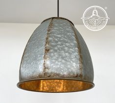 an old light hanging from a ceiling with snow on the bottom and rusted metal