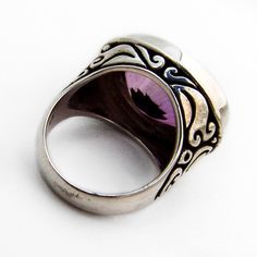 Vintage tall sterling silver cocktail ring, having ornate cut-work band and oval cut Amethyst centerpiece. This fabulous ring is a size 6 1/4 and weighs 13 grams. Eb7572 Formal Amethyst Oval Cabochon Ring In Silver, Silver Oval Signet Ring With Accent Stones, Classic Silver Oval Cabochon Amethyst Ring, Classic Silver Amethyst Ring Oval Cabochon, Classic Silver Amethyst Oval Cabochon Ring, Classic Silver Amethyst Ring With Oval Cabochon, Silver Oval Cabochon Amethyst Ring For Anniversary, Oval Silver Amethyst Ring Collectible, Collectible Oval Amethyst Ring In Sterling Silver