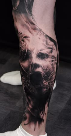 a man's leg with a lion tattoo on it and his face in the background