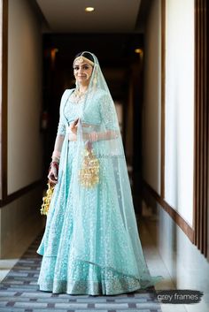 a woman in a blue and white wedding dress