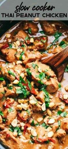 a close up of food in a pot with a wooden spoon and text overlay that reads slow cooker thai peanut chicken