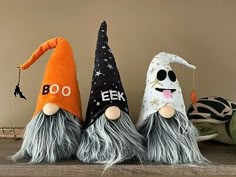 three halloween gnomes sitting next to each other