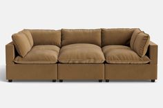 a brown couch with pillows on top of it