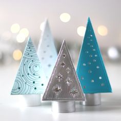 three small christmas trees sitting next to each other