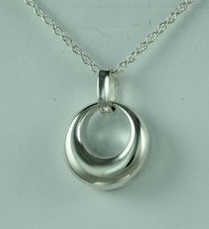 This beautiful cremation locket is a unique way to hold a loved one close. This pendant can hold a small amount of cremains, lock of hair, or dirt from the sacred burial grounds. This piece comes on an 18" matching chain and 1/2 inch in size. GOOD TO KNOW: ♥ Available in Sterling Silver ♥THIS PENDANT CAN BE ENGRAVED-SEE PERSONALIZATION SECTION ♥Fill kit included with pendant CARE: ♥Sterling Silver is resistant to rust, corrosion, and tarnishing, but we still recommend for the longevity of the pe Silver Crescent Jewelry For Formal Occasions, Classic Crescent Jewelry As A Gift, Classic Crescent Jewelry For Gifts, Classic Crescent Jewelry For Gift, Classic Crescent Jewelry Gift, Classic Crescent-shaped Gift Jewelry, Keepsake Jewelry With Detachable Pendant, Detachable Pendant Keepsake Jewelry, Silver Jewelry With Large Pendant For Keepsake