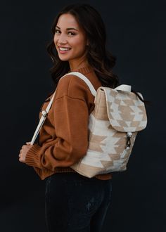 Tan and cream Aztec inspired backpack Clasp closure on the front Adjustable straps and handle Measures 14" x 11.5" x 4.5" 100% Cotton Lining: 100% Polyester Beige Backpack For On-the-go, Casual Cream Backpack With Adjustable Strap, Cream Bag With Adjustable Straps For Daily Use, Casual Cream Satchel Backpack, Canvas Tote Backpack With Adjustable Strap, Beige Canvas Satchel Backpack, Beige Satchel Backpack With Adjustable Strap, Cream Colored Backpack-style Shoulder Bag With Adjustable Strap, Cream Bags With Adjustable Straps For Everyday