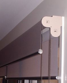 a close up of a sliding glass door with chains hanging from it's side