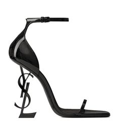 Find SAINT LAURENT Leather Opyum Sandals 110 on Editorialist. Saint Laurent redefines the heel with the Opyum pumps. By replacing the traditional stiletto with its own sculptural monogram, modernist flair is injected into an otherwise understated strappy silhouette - ready to be partnered with a little black dress to turn heads at your next soirée. Dr Shoes, Ysl Heels, Yves Saint Laurent Shoes, Patent Shoes, Womens Wedding Shoes, Designer Sandals, High Heel Sandals, Black Heels, Leather Sandals