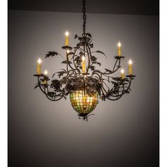 a chandelier hanging from the ceiling with lit candles in front of grey background