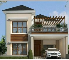 a white car parked in front of a two story house with balconies on the second floor