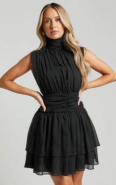 Get ready to turn heads in the Adriel Mini Dress. This trendy sleeveless dress features a high neck and ruched waist, creating a flattering fit and flare silhouette that is perfect for any occasion. Made from luxurious polyester fabric, this black mini dress is both stylish and comfortable. Whether you're heading out for a day of shopping or hitting the dance floor at a party, this dress will make you feel confident and chic. Embrace your fashion-forward side with the Adriel Mini Dress - it's ti At A Party, Black Mini Dress, The Dance, Dance Floor, Black Mini, High Neckline, Fit Flare Dress, Mini Black Dress, Fit & Flare