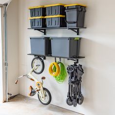 there is a bike and several bins on the wall