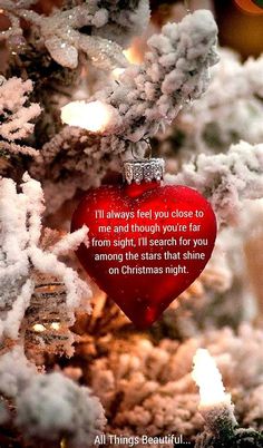 a heart shaped ornament hanging from a christmas tree with the words, i'll always feel you close to me and though you're far from