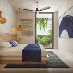 a bedroom with a bed, ceiling fan and pictures on the wall above it that are hanging