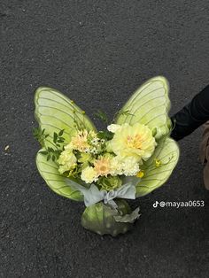 a person holding a bouquet of flowers on the ground