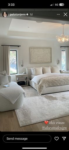 a large white bed sitting inside of a bedroom