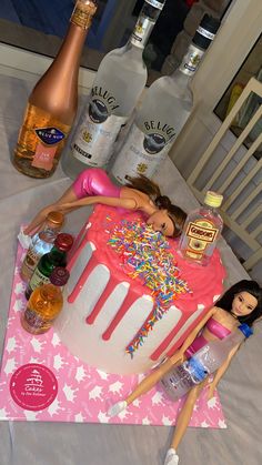 a barbie doll laying on top of a birthday cake