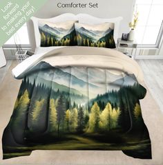 the comforter set is designed to look like a mountain scene with pine trees and mountains