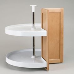 a white round shelf with a wooden cabinet behind it