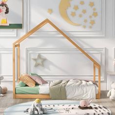 a child's bedroom with a doll house bed and toy elephant on the floor