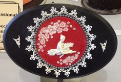 a black plate with red and white designs on it