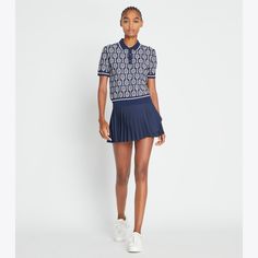 Designed to be worn on and off the court, a classic polo features a vintage-inspired racquet print and contrast striped rib-knit collar, cuffs and hem. Crafted in a comfortable and breathable tech knit, the versatile top can dress up with trousers or down with a pleated tennis skirt. Sporty Polo Sweater With Ribbed Cuffs, Sporty Collared Polo Sweater With Ribbed Cuffs, Classic Fitted Polo Sweater With Striped Collar, Casual Polo Sweater With Contrast Stripes, Casual Collared Polo Sweater With Contrast Stripes, Tory Burch Outfits, Overlay Skirt, Pleated Tennis Skirt, Knit Polo