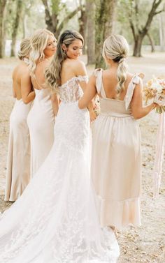 three bridesmaids are standing in the woods with their backs turned to one another